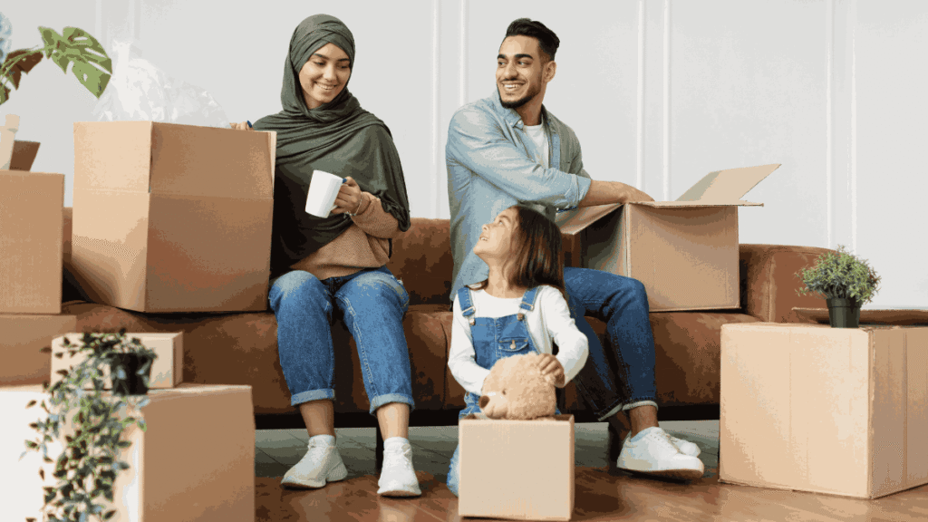Smiling family unpacking boxes in their new home
