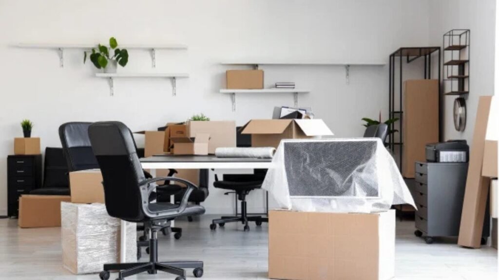 Office equipment being packed and labeled by movers