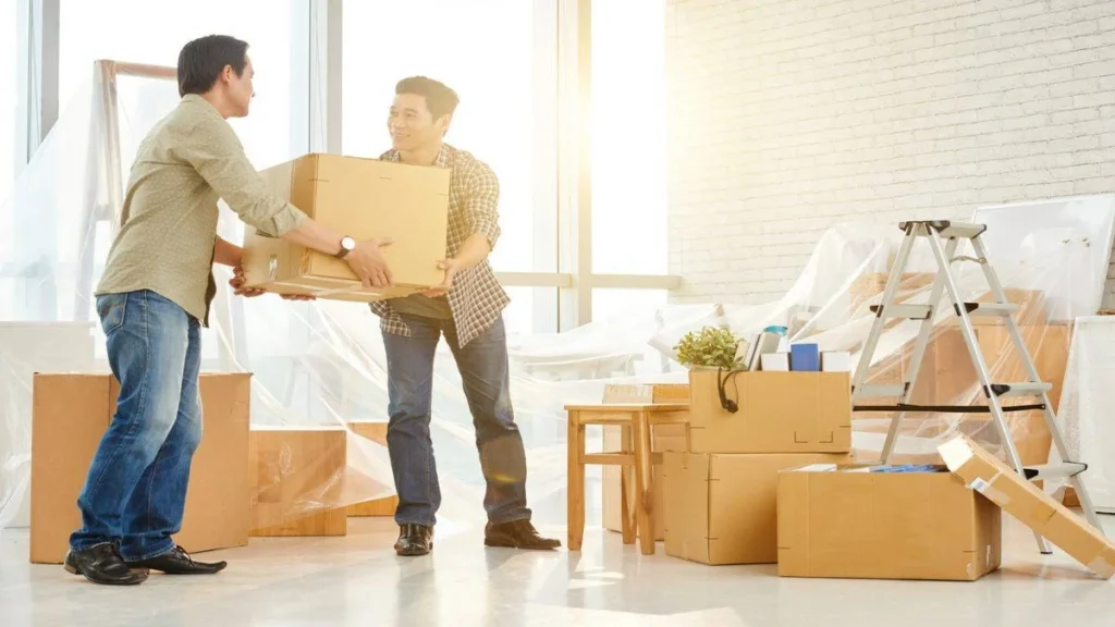 Skilled movers unpacking and organizing boxes during a house move in Abu Dhabi