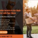 Trained movers packing a villa living room with boxes and wrapping materials
